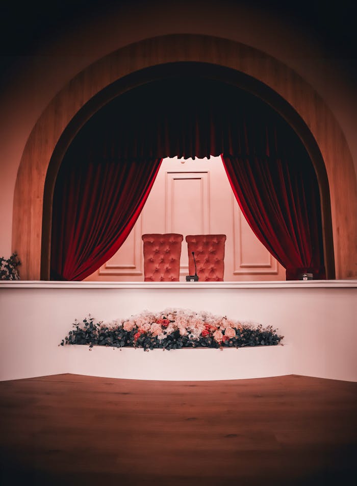 Chic interior with red curtains and floral arrangement, perfect for formal events.